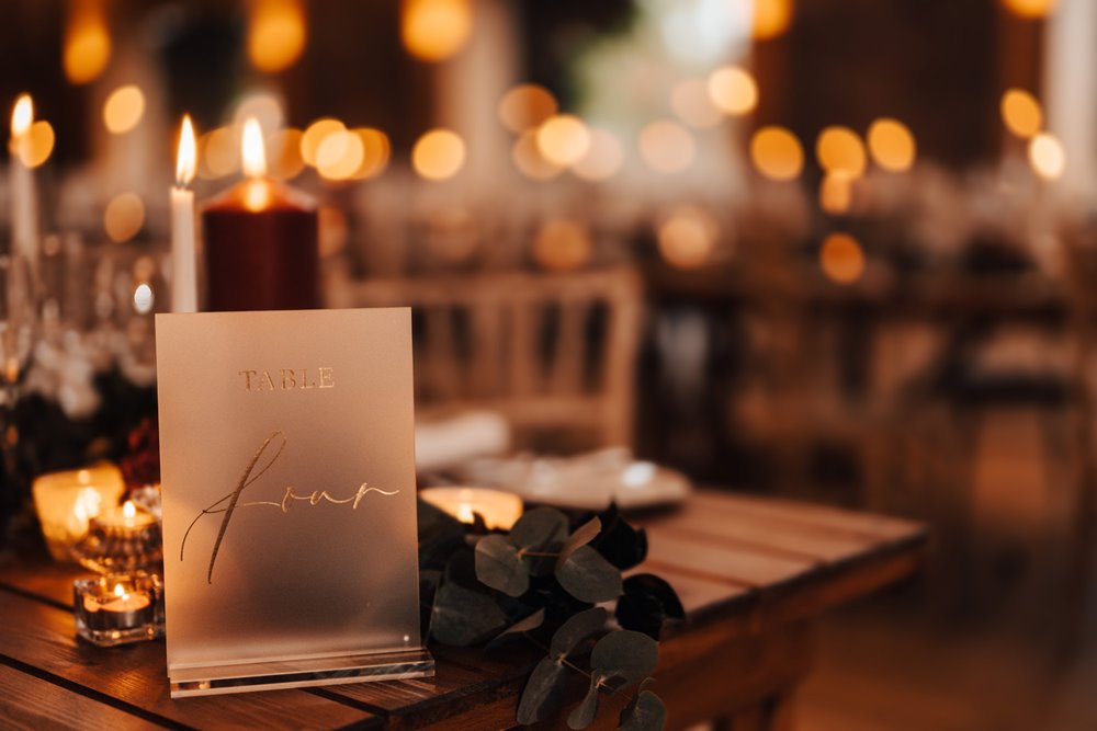 gold table placements and candles for a magical christmas wedding in the cotswolds