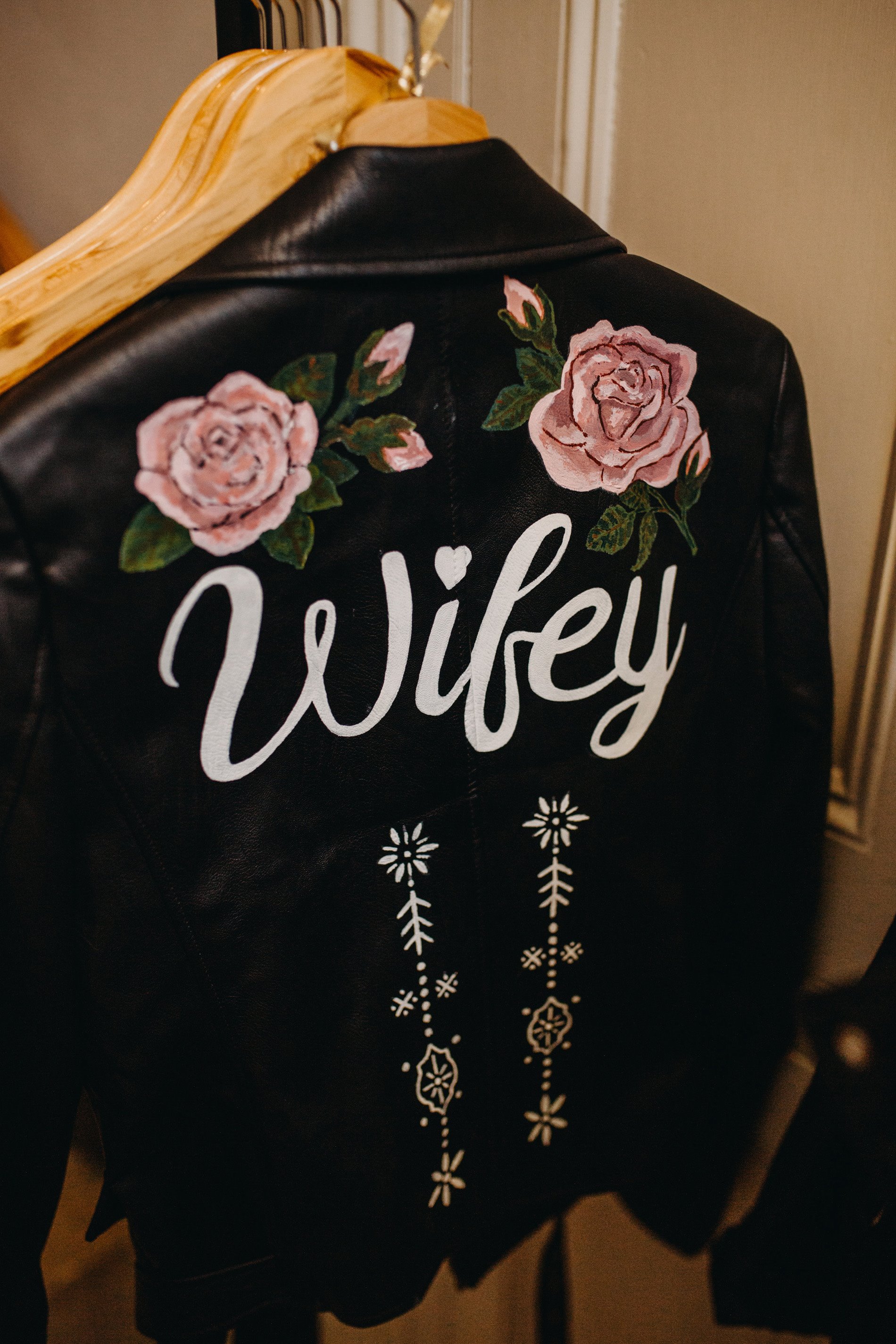 This Rock n roll bride wore a leather jacket with wifey painted on the back at her rocking real wedding at elmore court