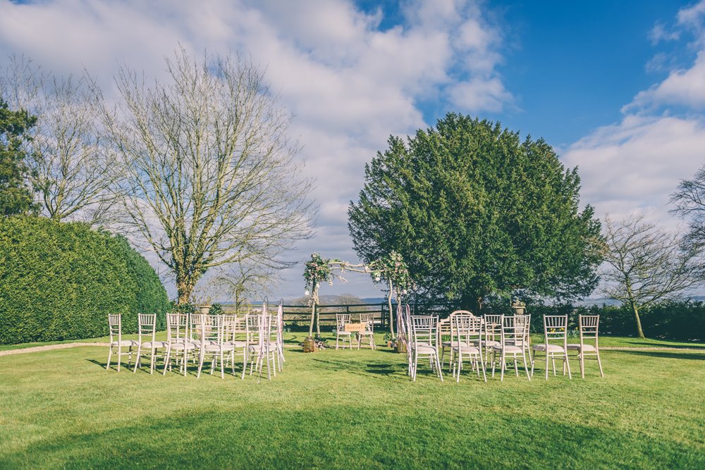 Garden wedding ceremony set up on the lawn for an outdoor wedding at elmore court in the cotswolds