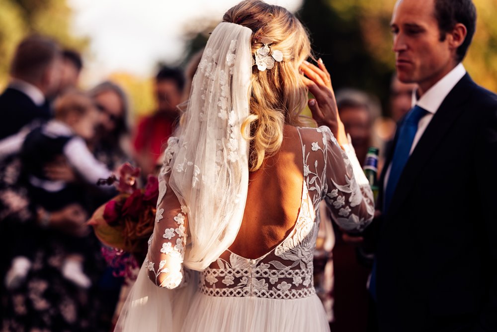 cool bride in Beautiful boho dress in sunshine outdoor wedding in the cotswolds