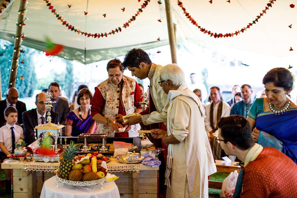 Colourful Gay fusion Indian wedding in a kata tent decorated with flower garlands