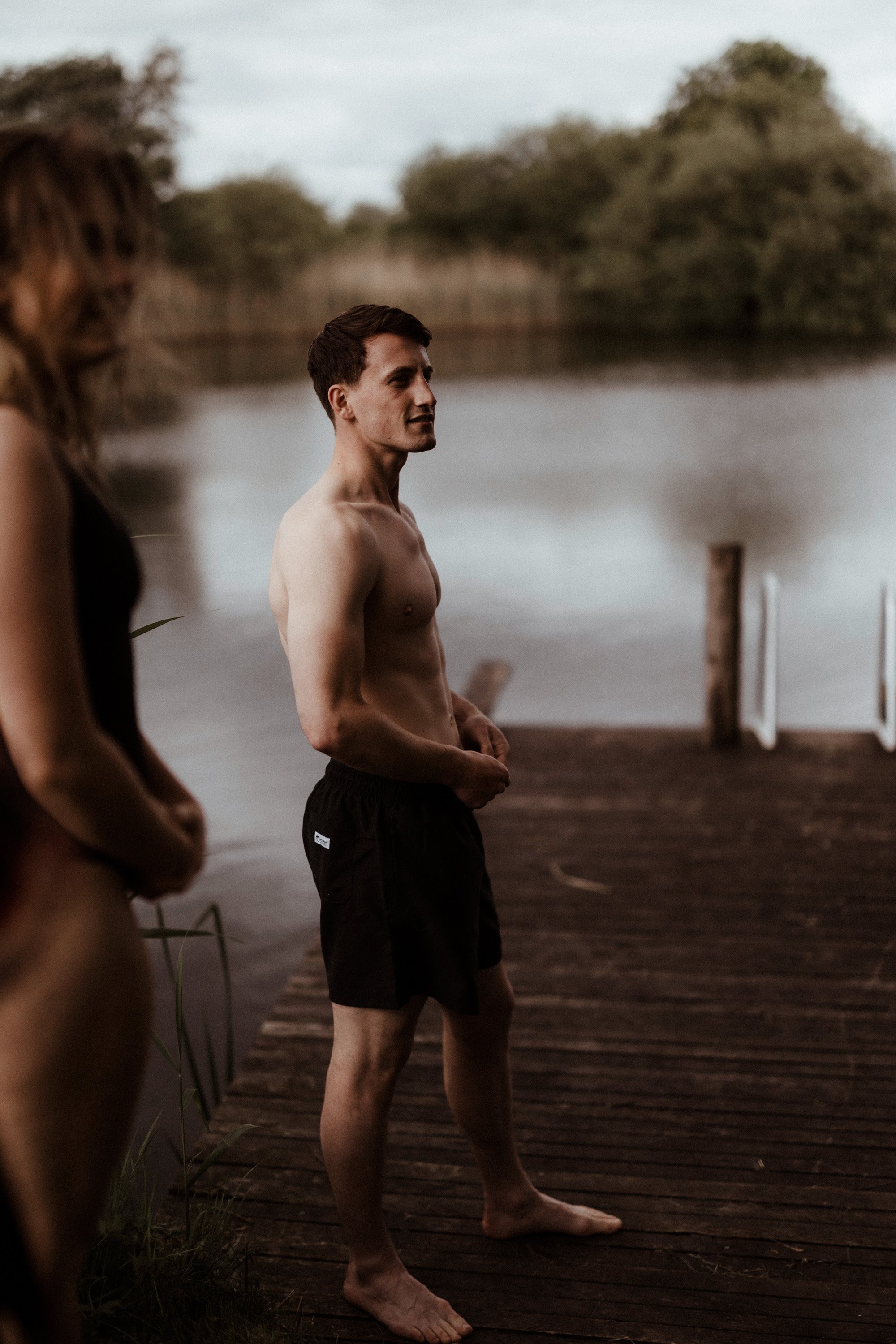 Bride and groom prepare for wild swim on their wedding day at rewilding wedding venue elmore court in Gloucester UK