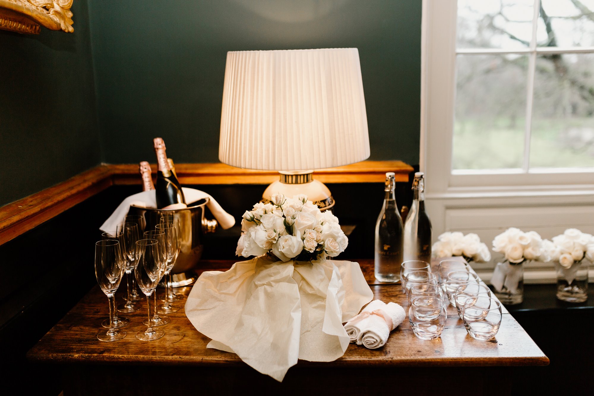 Bottles of champagne cooling on a table setting, in preparation for toasts at a wedding reception