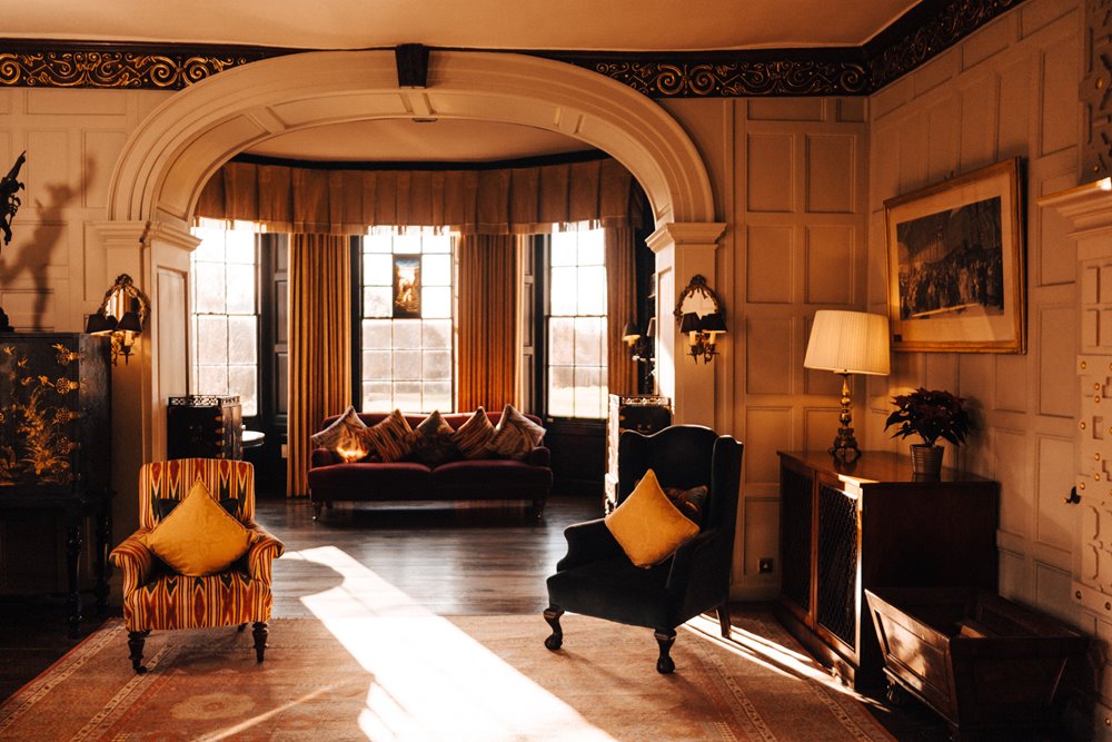 cosy christmas drawing room in an old stately home wedding venue in the cotswolds
