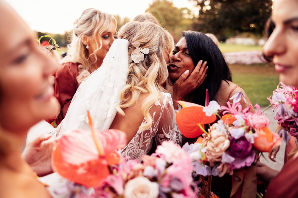Colourful bridesmaids and cool bride in sunny outdoor wedding at elmore court