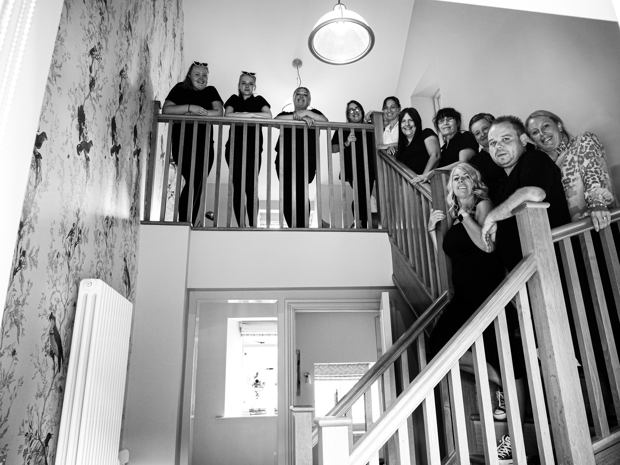 Housekeeping team at elmore court standing up the stair way in the coach house