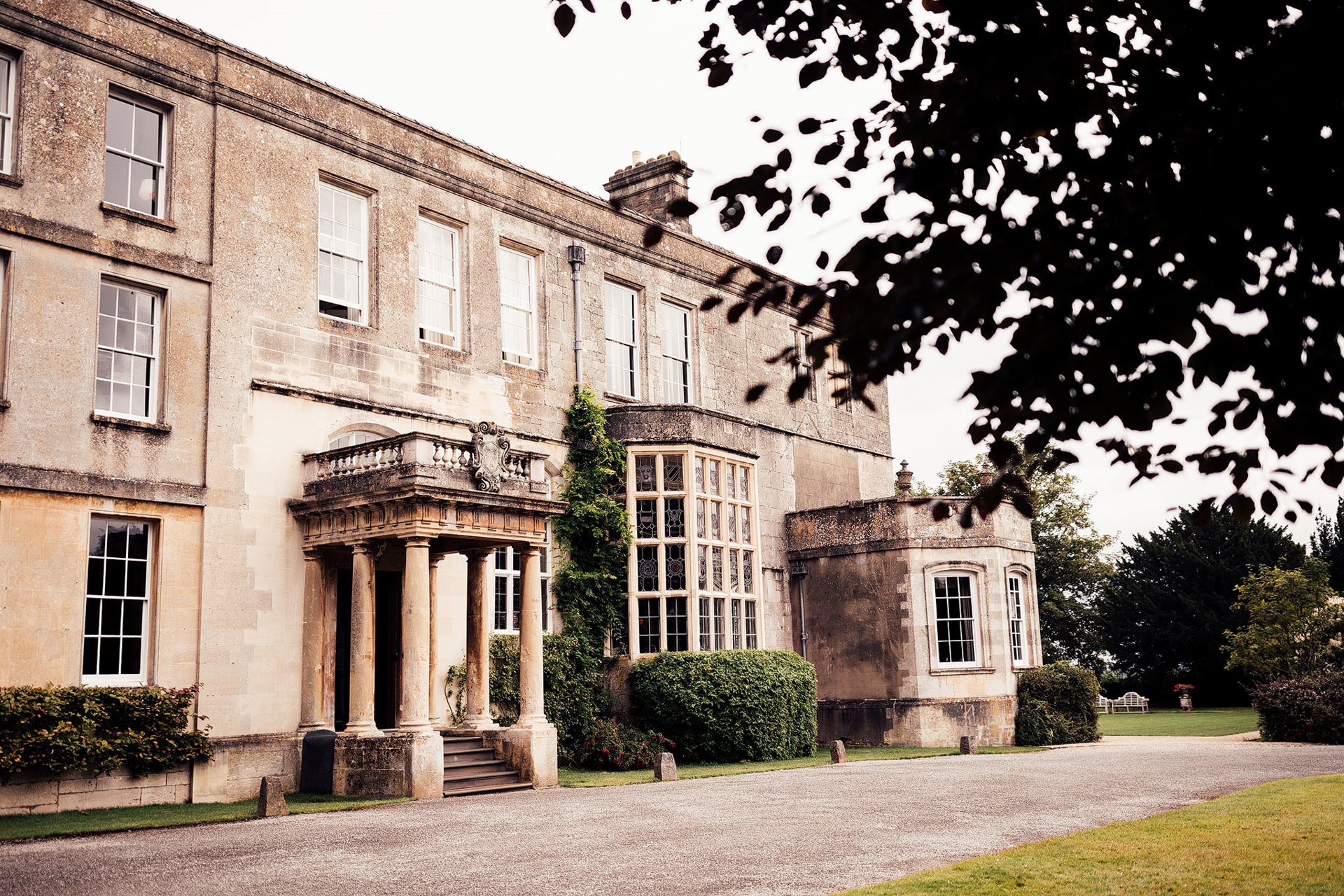 Cotswolds wedding venue stately home elmore court in the summer for a persian red and pink wedding with a bridesman