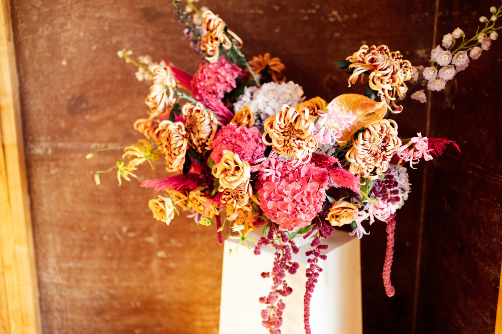 Colourful wedding flowers with a tropical theme for a party wedding in a stately home