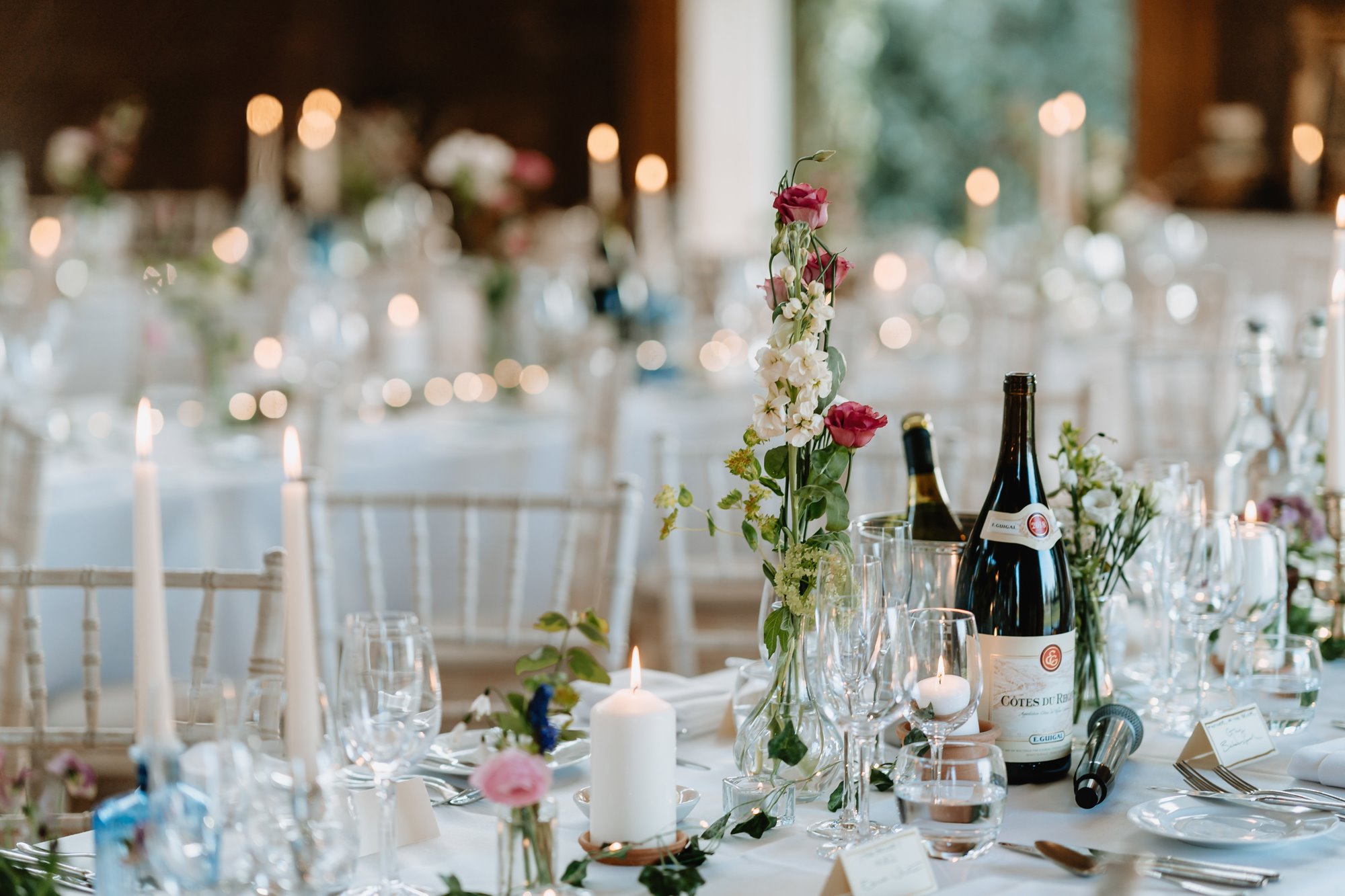 elegantly decorated white wedding reception tables