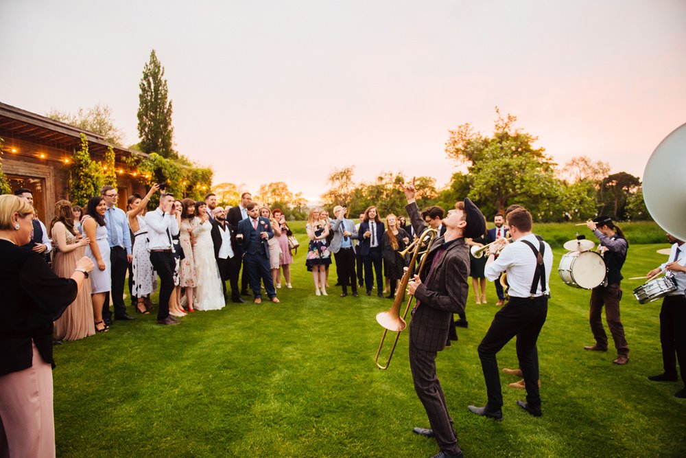 Outdoor wedding fun with brass band at Elmore Court for post pandemic festival wedding joy