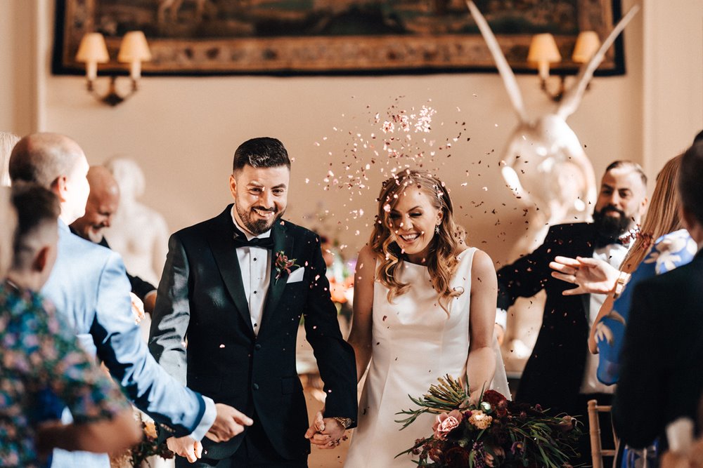 autumn wedding ceremony confetti shot at a stately home in gloucestershire