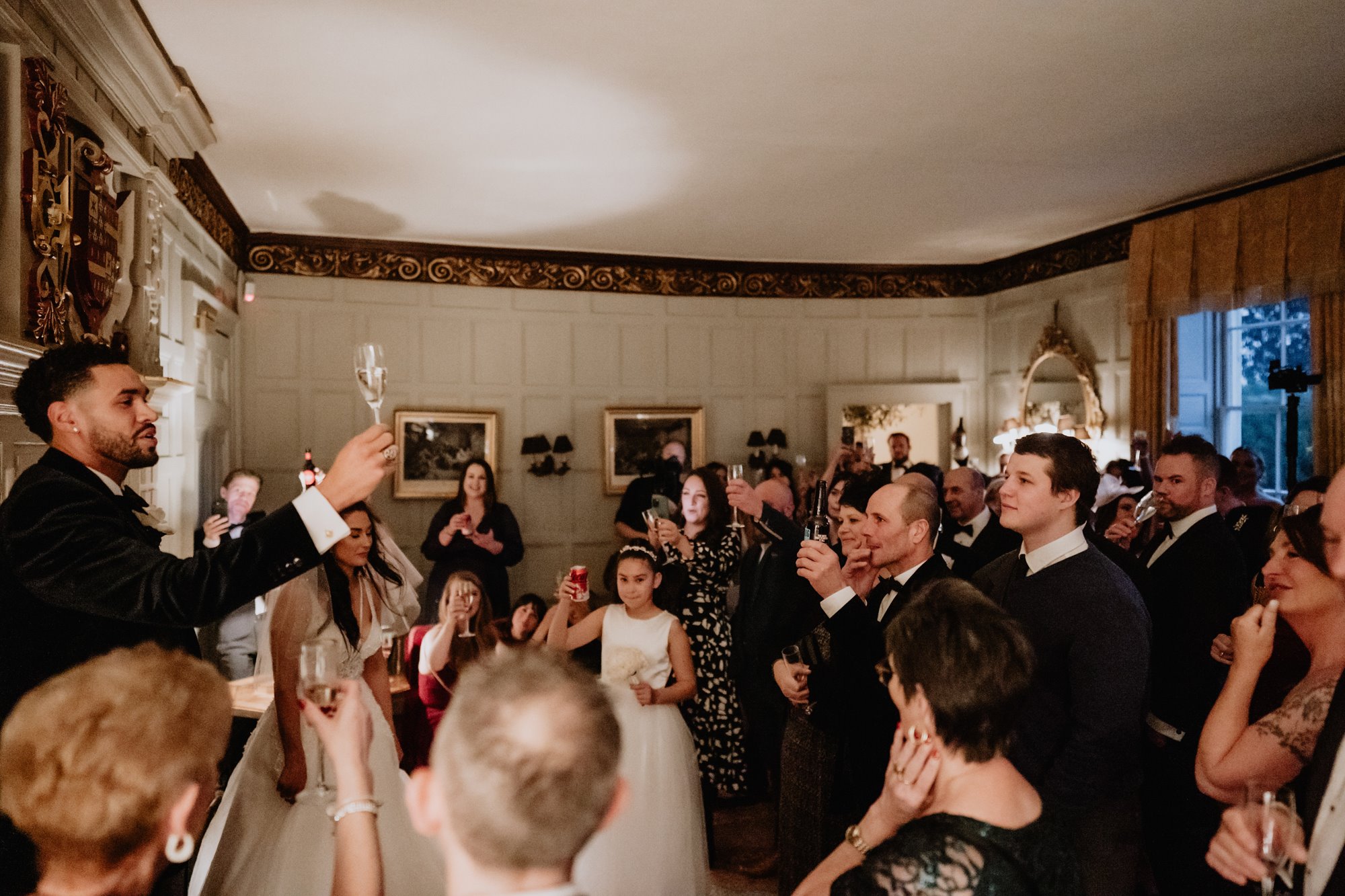 groom toasting with friends and family at the reception of his wedding at Elmore Court