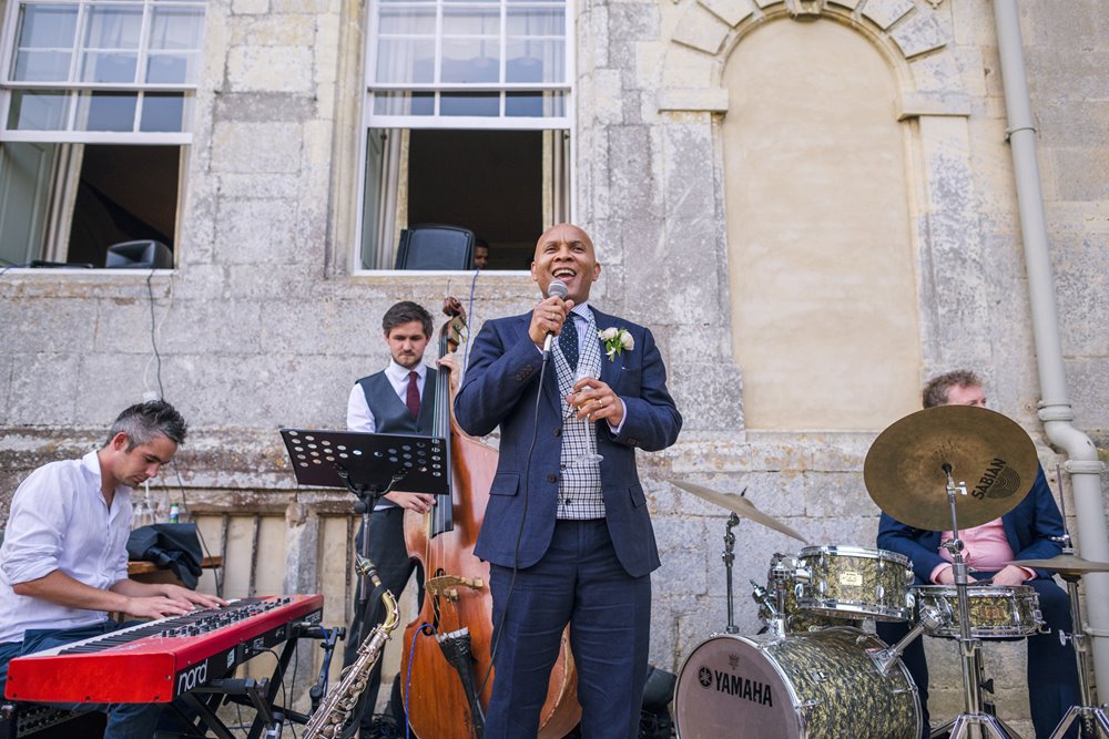 Groom sings with the jazz band at his own wedding