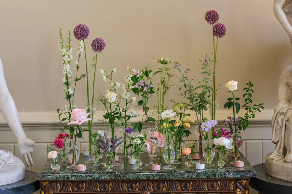 Wildflowers and garden flowers decorating same sex ceremony space at elmore court