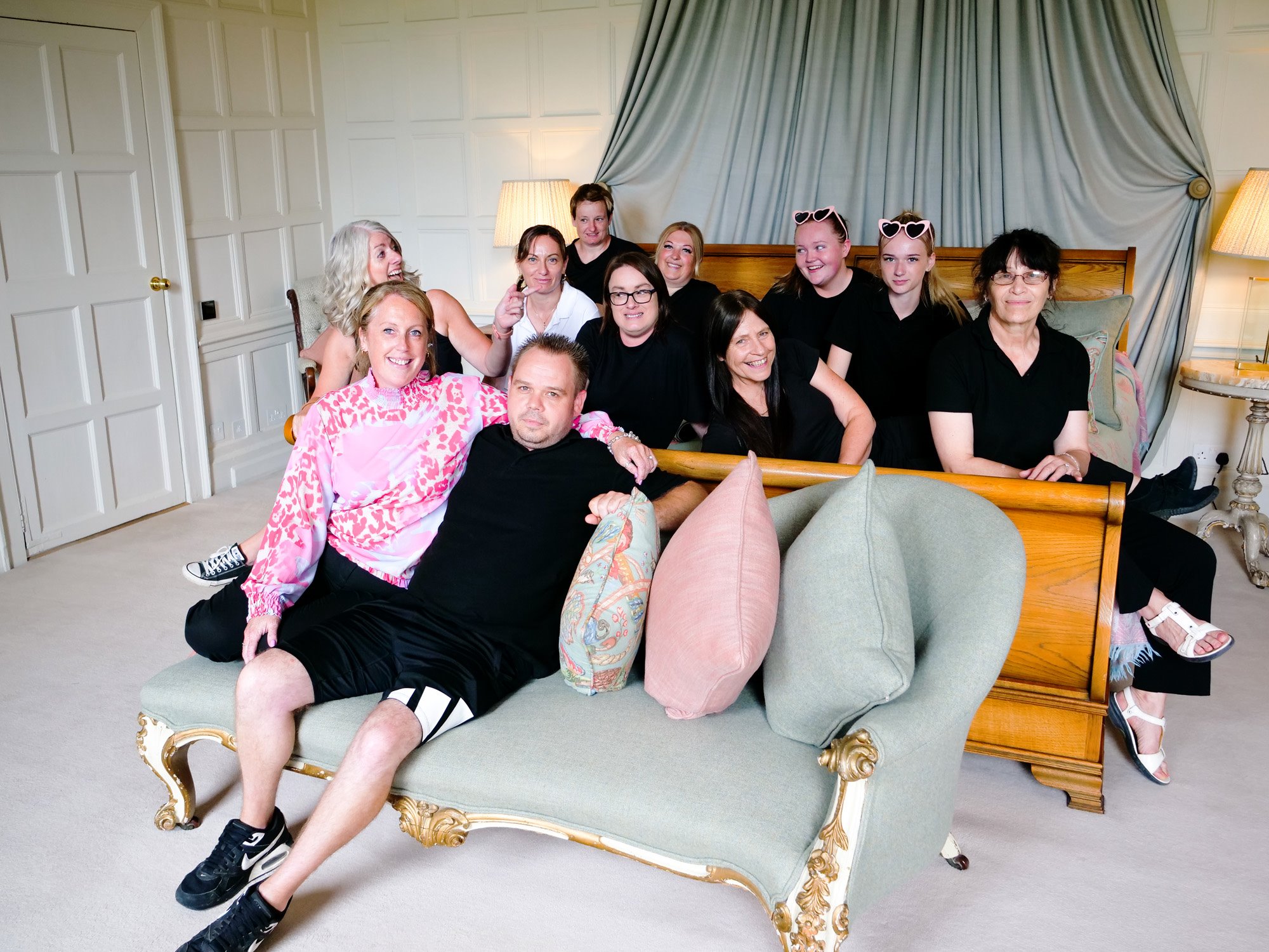 Housekeeping team of mansion house wedding venue Elmore court in the smoking room showing just how huge that emperor size bed is