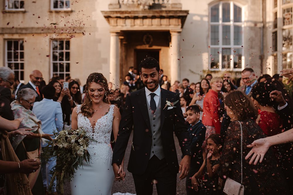 Indian English fusion wedding newlyweds leave elmore court surrounded by hundreds of guests