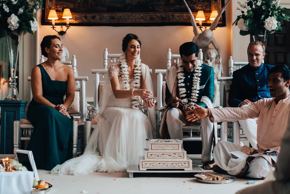 Indian wedding ceremony over fire inside the hall at elmore court