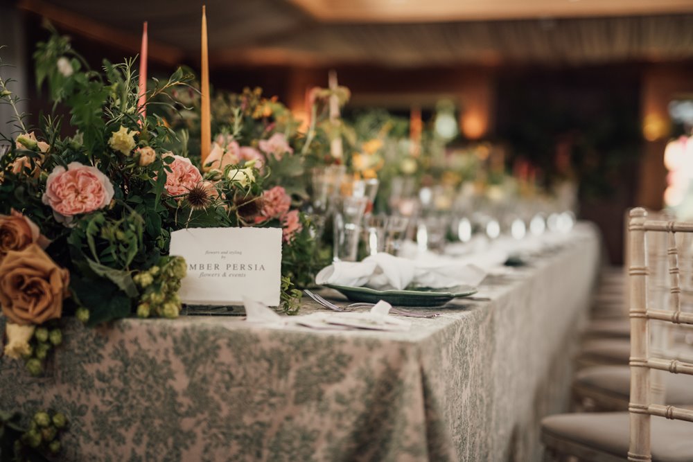 Wedding reception flowers on tables by amber persia