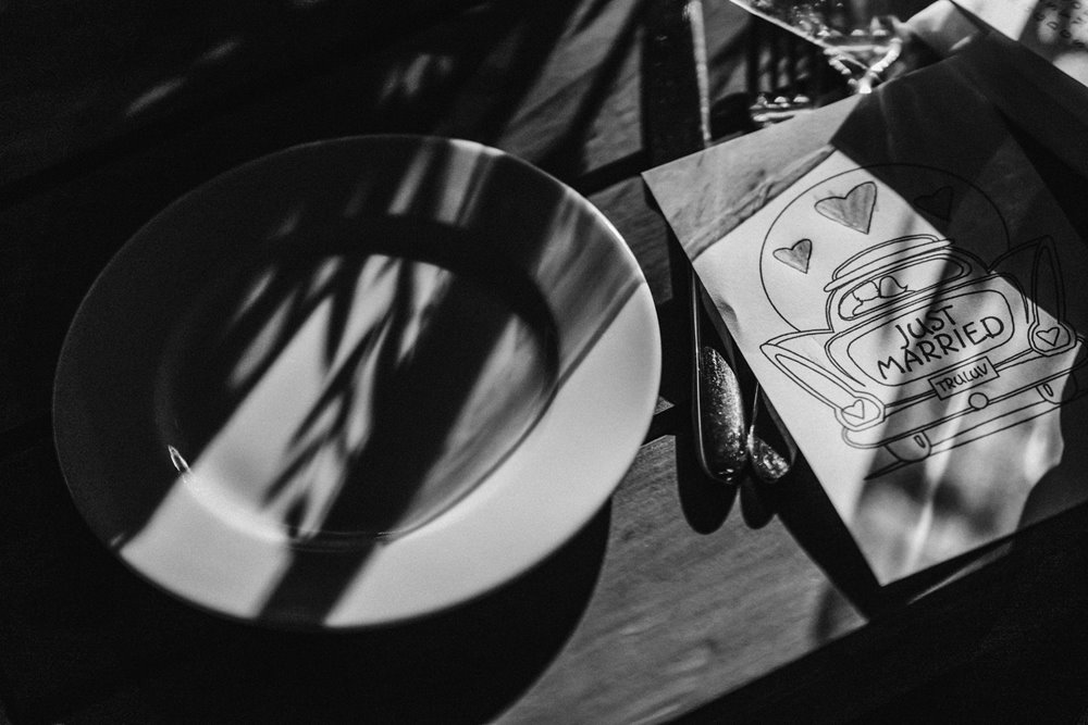 Moody photo of wedding table details and childrens place settings at an october wedding at elmore court