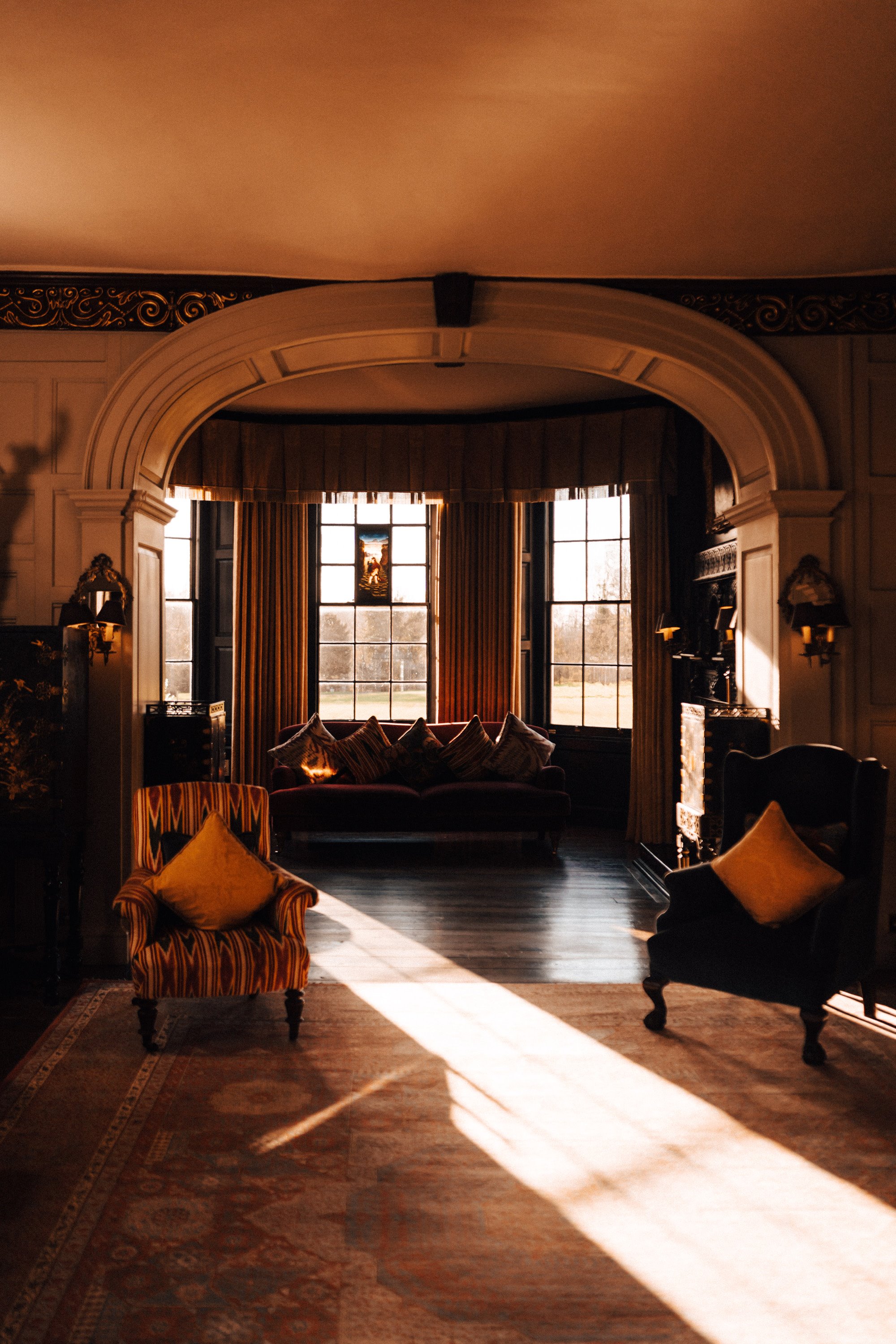 cosy drawing room in an old mansion house wedding venue with winter sun streaming in the windows
