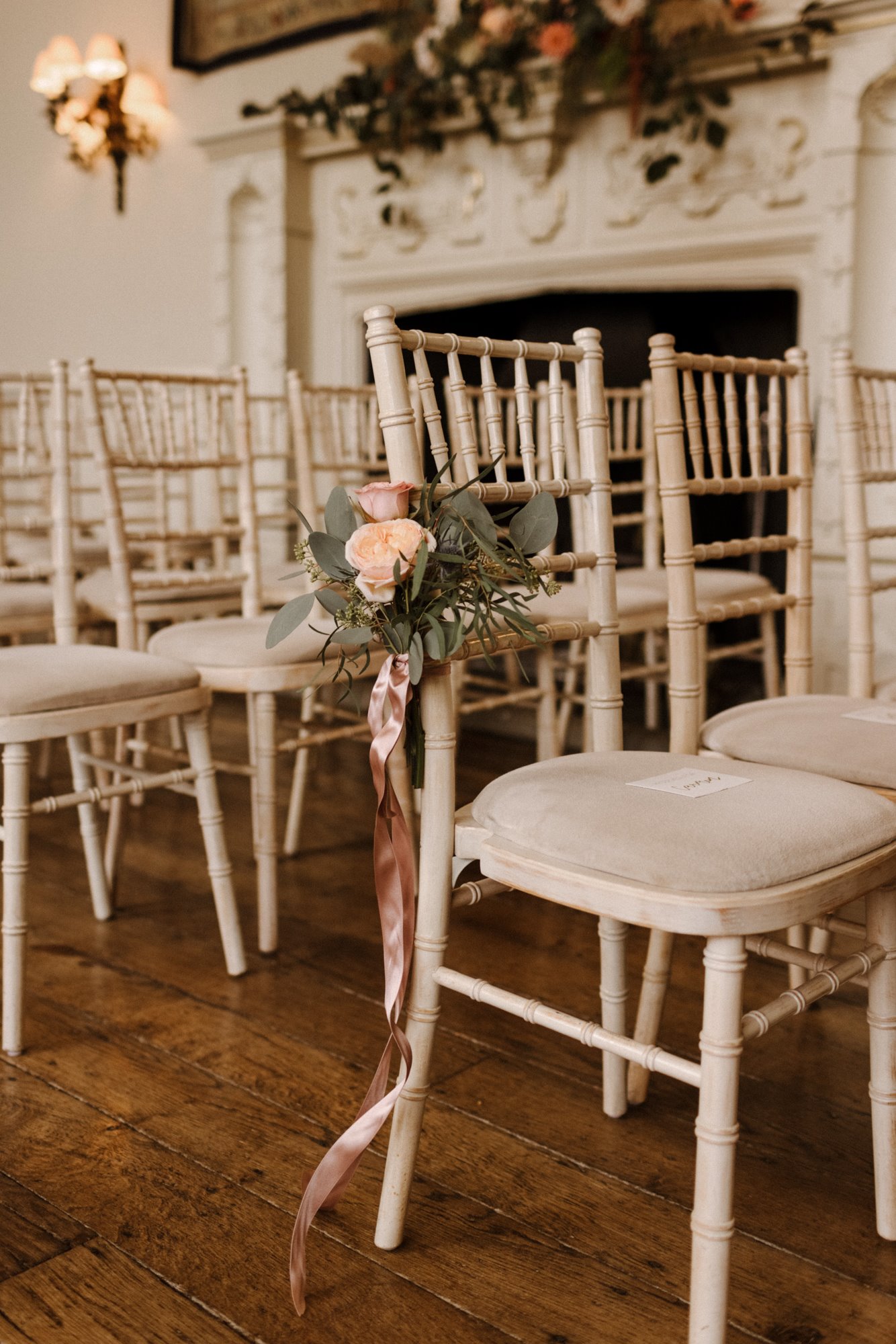 wedding ceremony decor on aisle chairs at stately home