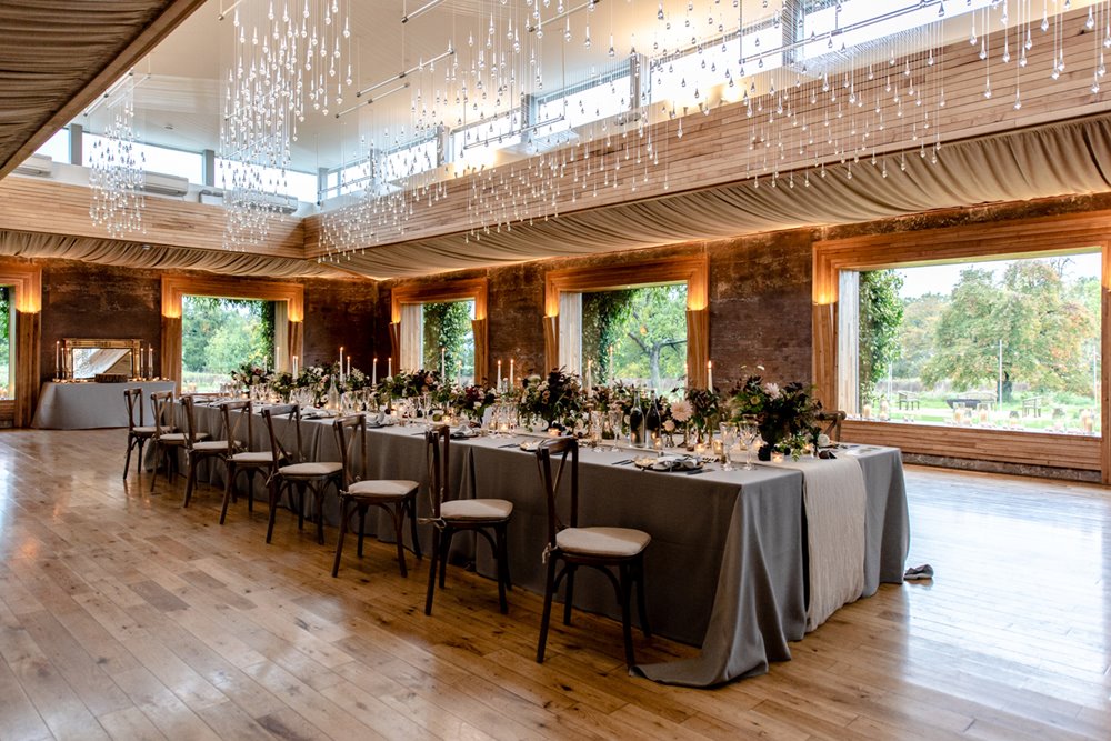 micro wedding reception with one table laid with candles and flowers in the beautiful gillyflower at elmore court