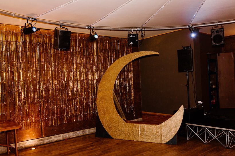Giant gold moon and gold curtain for celestial wedding at stately home elmore court