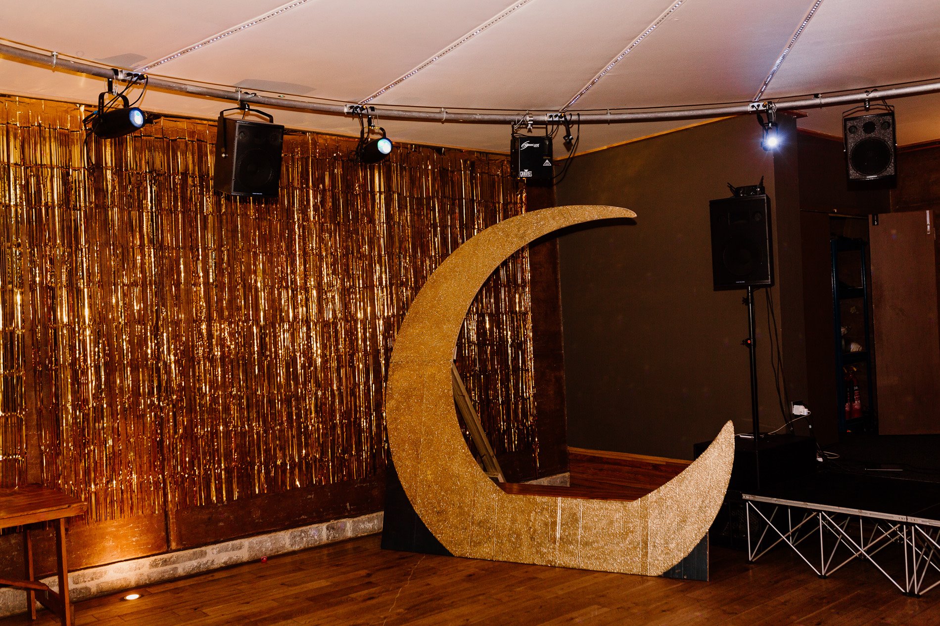 Giant gold moon and gold curtain for celestial wedding at stately home elmore court