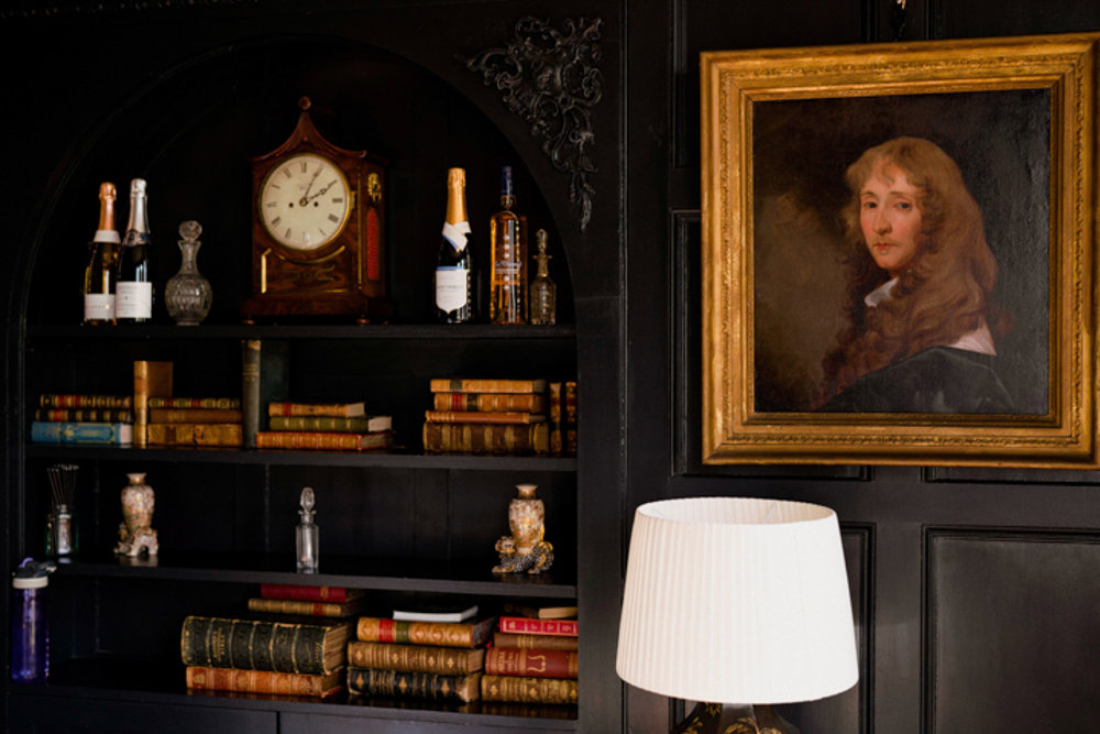 Champagne on a book shelf in historic house elmore court