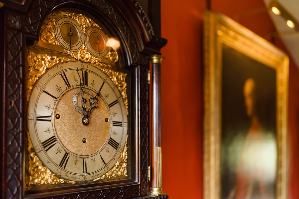 a grandfather clock in red hallway of Elmore Court - a party pad with ancient pedigree