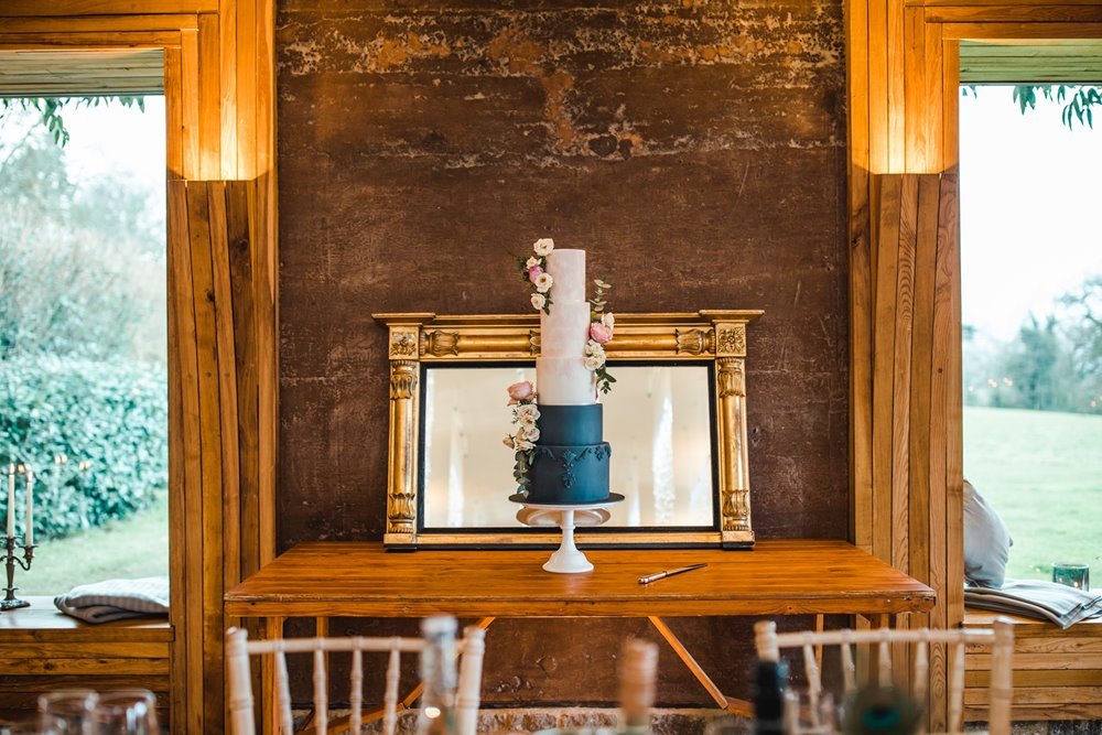 Designer wedding cake with 6 tiers in white and blue for a wedding at elmore court