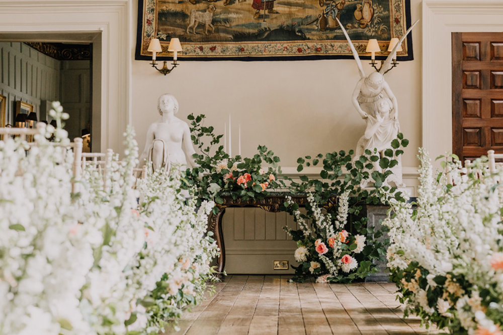White and pink wild wedding flowers for a ceremony in the hall at elmore court