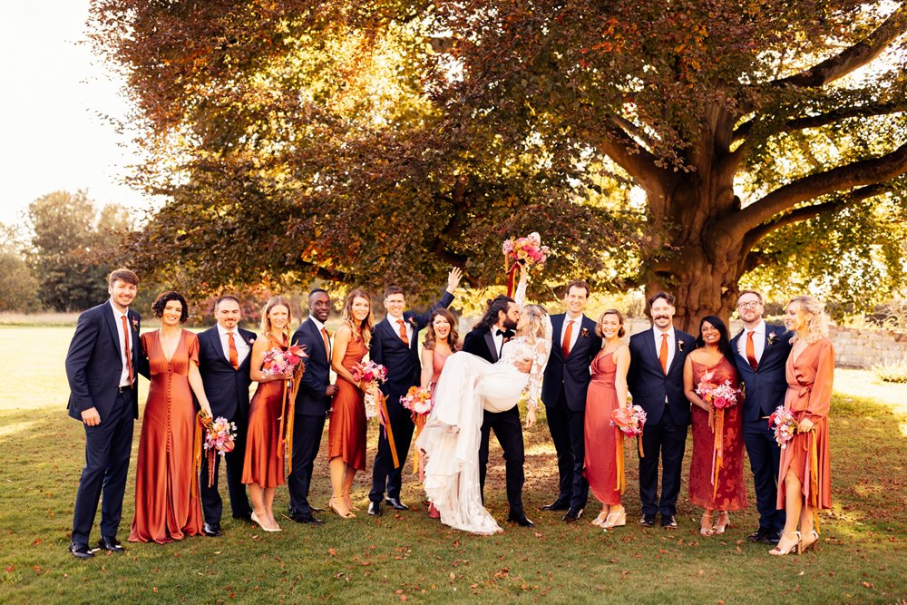 Fun mixed wedding party under huge beech tree at elmore court