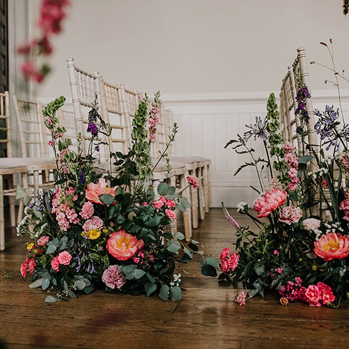 Beautiful big pink blooms for statement wedding aisle at elmore court in the cotswolds