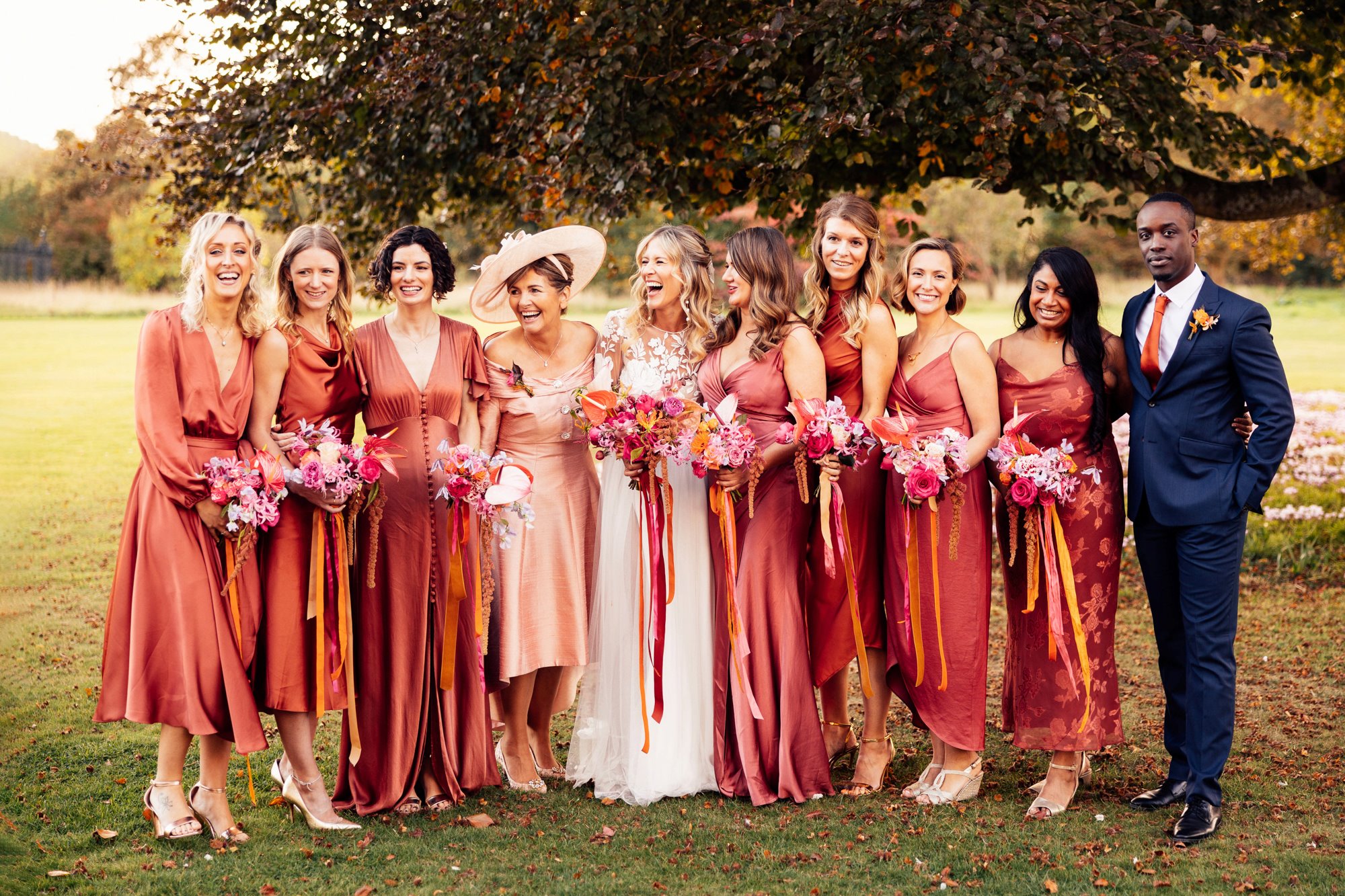 Bridemaids in burnt orange for a beautiful boho luxe wedding at elmore court in the cotswolds