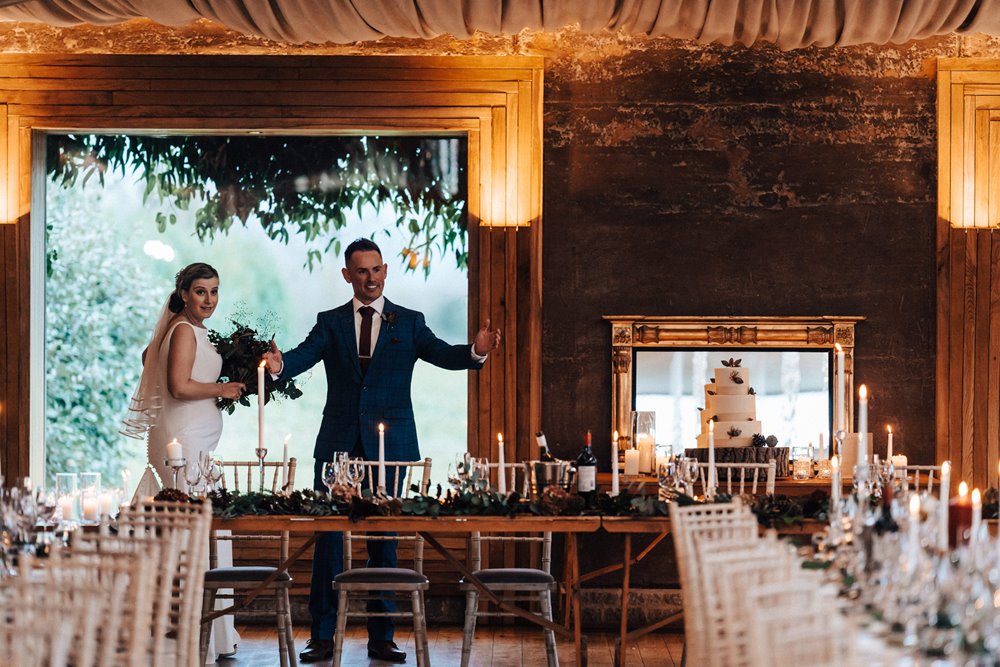 happy bride and groom look at their beautiful winter wedding reception