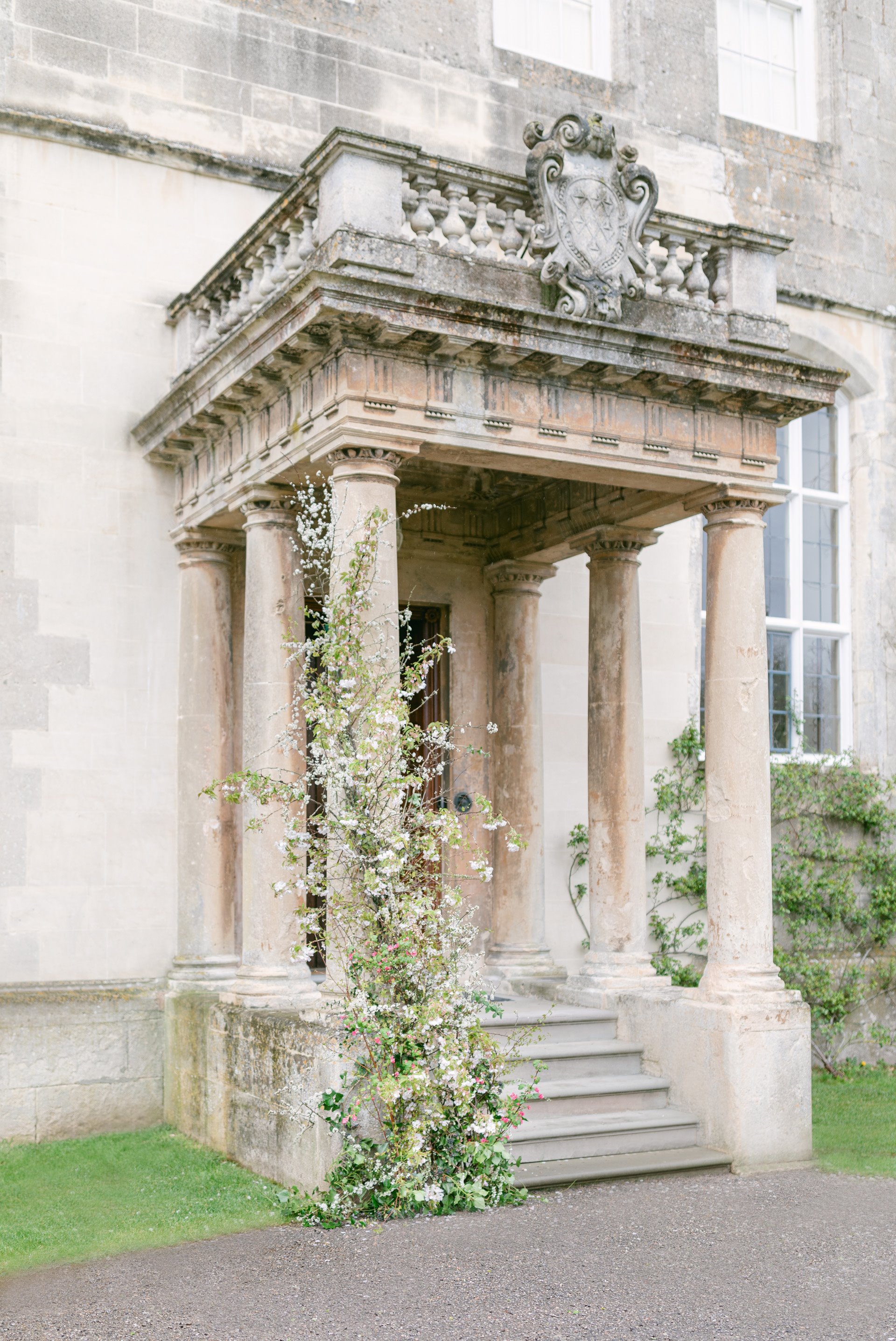 Front steps and columns of mansion house Elmore Court decorated in foliage for an open day wedding fair in September