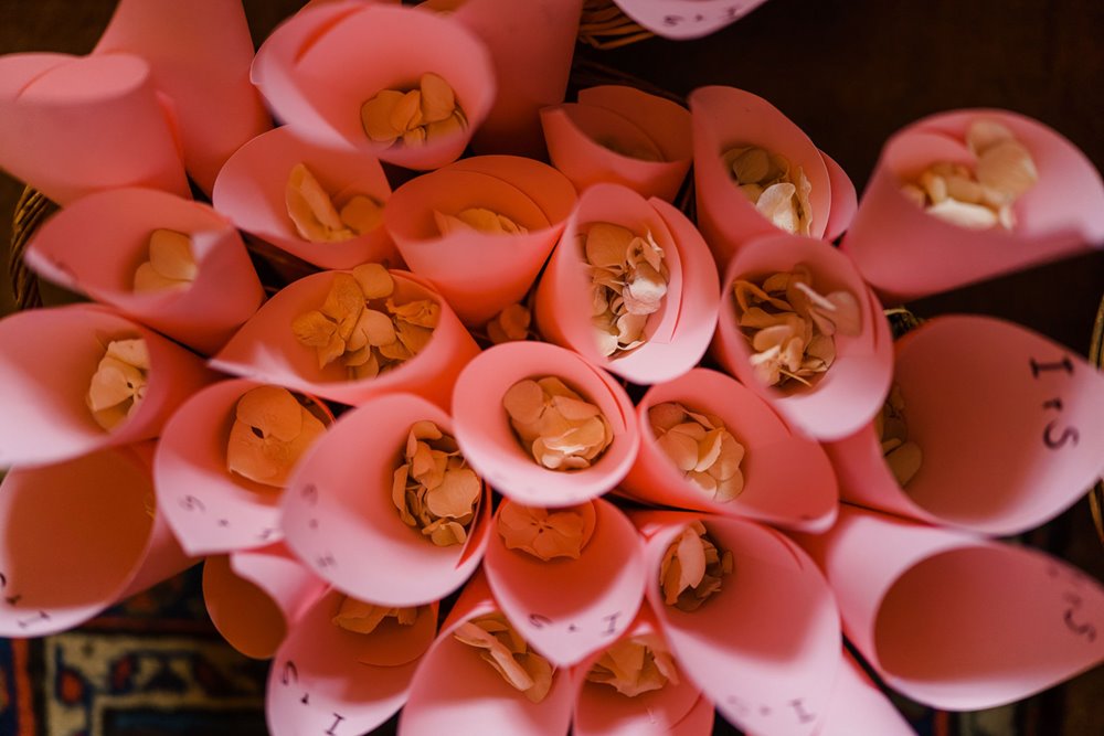 Pink Confetti cones holding petals to be thrown at newlyweds at jewish wedding ceremony outdoors