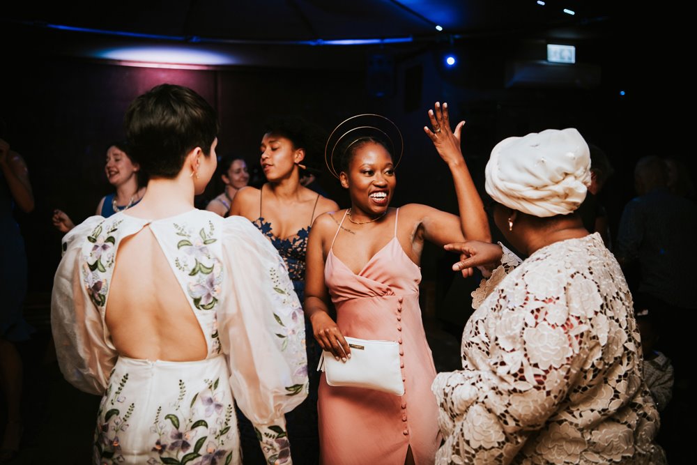 Beautiful black bride shines like a Goddess in pink silk reception dress and golden halo crown on her same-sex wedding day at elmore court