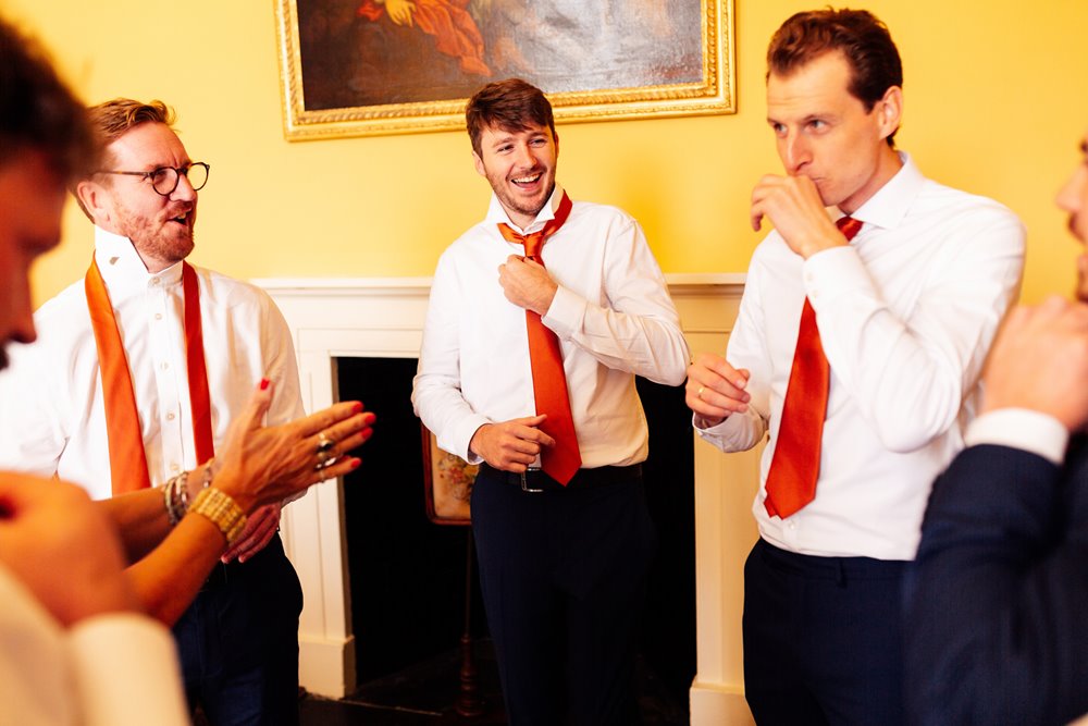 groomsmen in colourful ties get ready in the morning