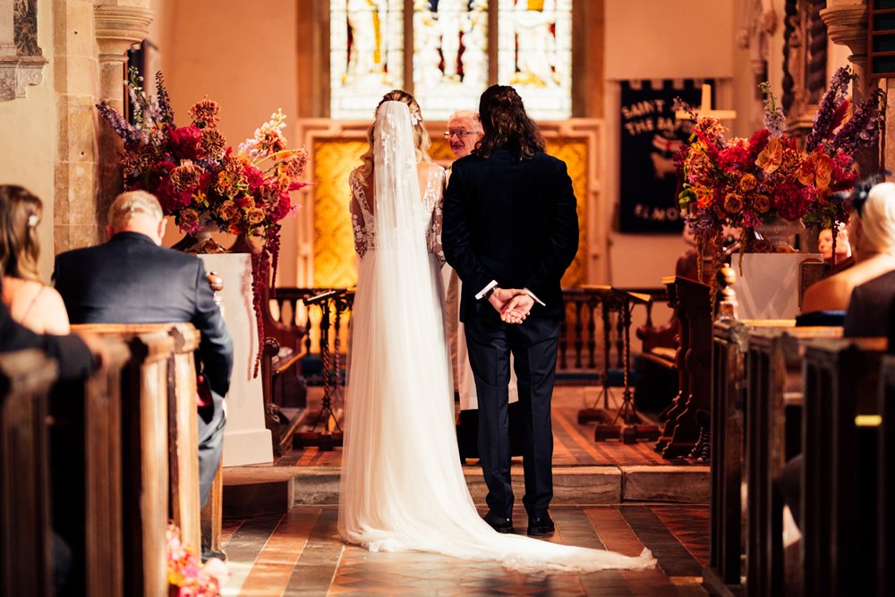 bride and groom in wedding ceremony at Elmore church known as the prettiest church in England to marry in the uk