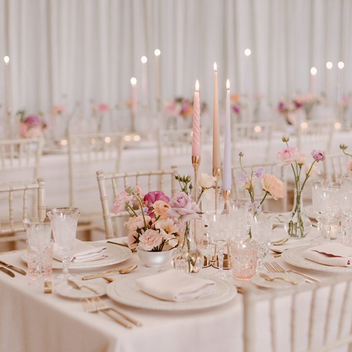 Whimsical table setting at a romantic Elmore Court wedding, with flowers and candles on a beautifully dressed table 