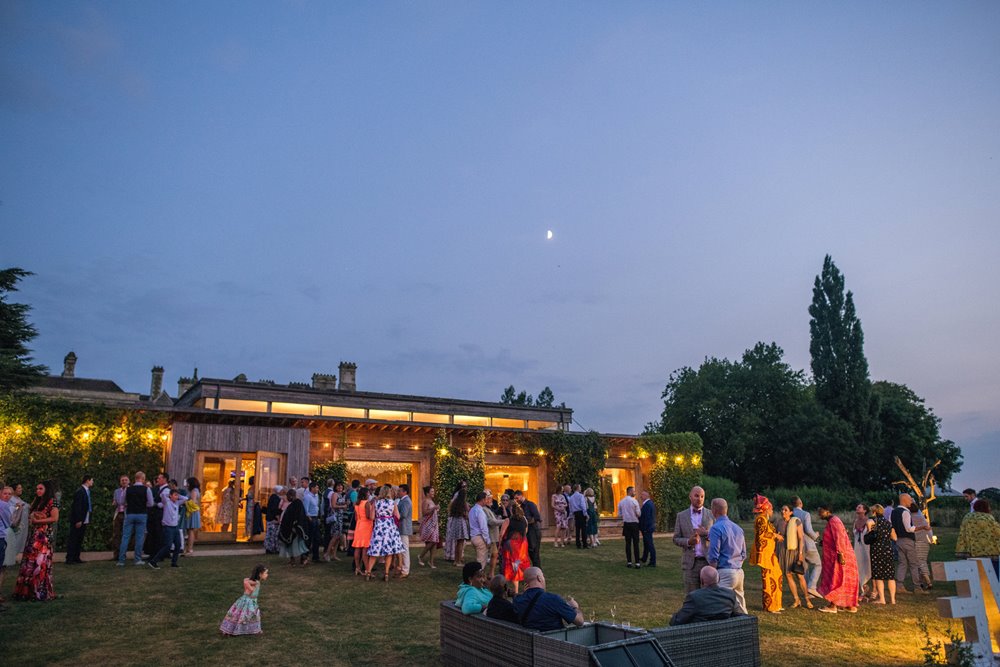 Guests outside the gillyflower at beautiful gay wedding with a festival feel 