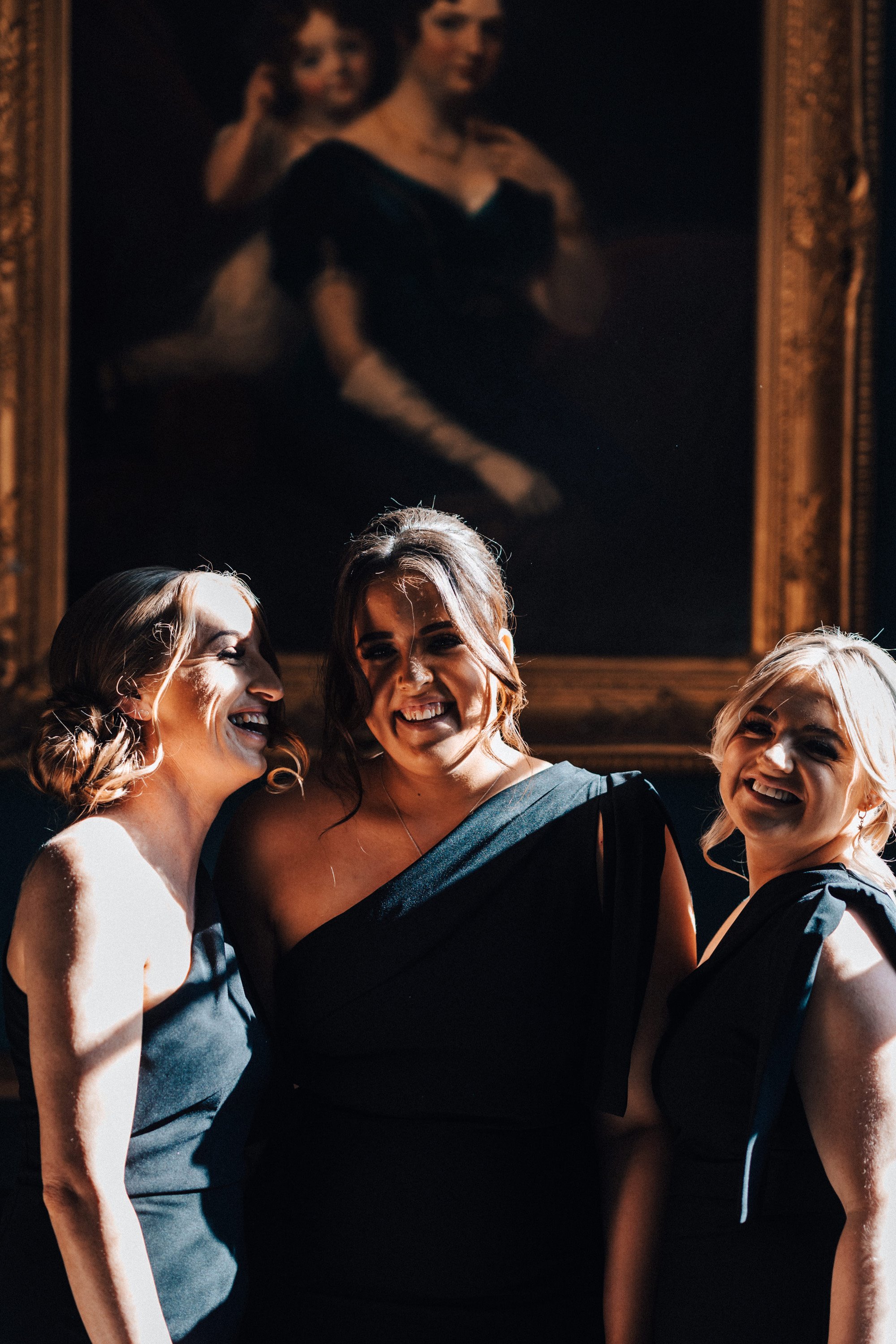 Bridesmaids in black dresses for a Rock n roll wedding style near Halloween in October in a English country house