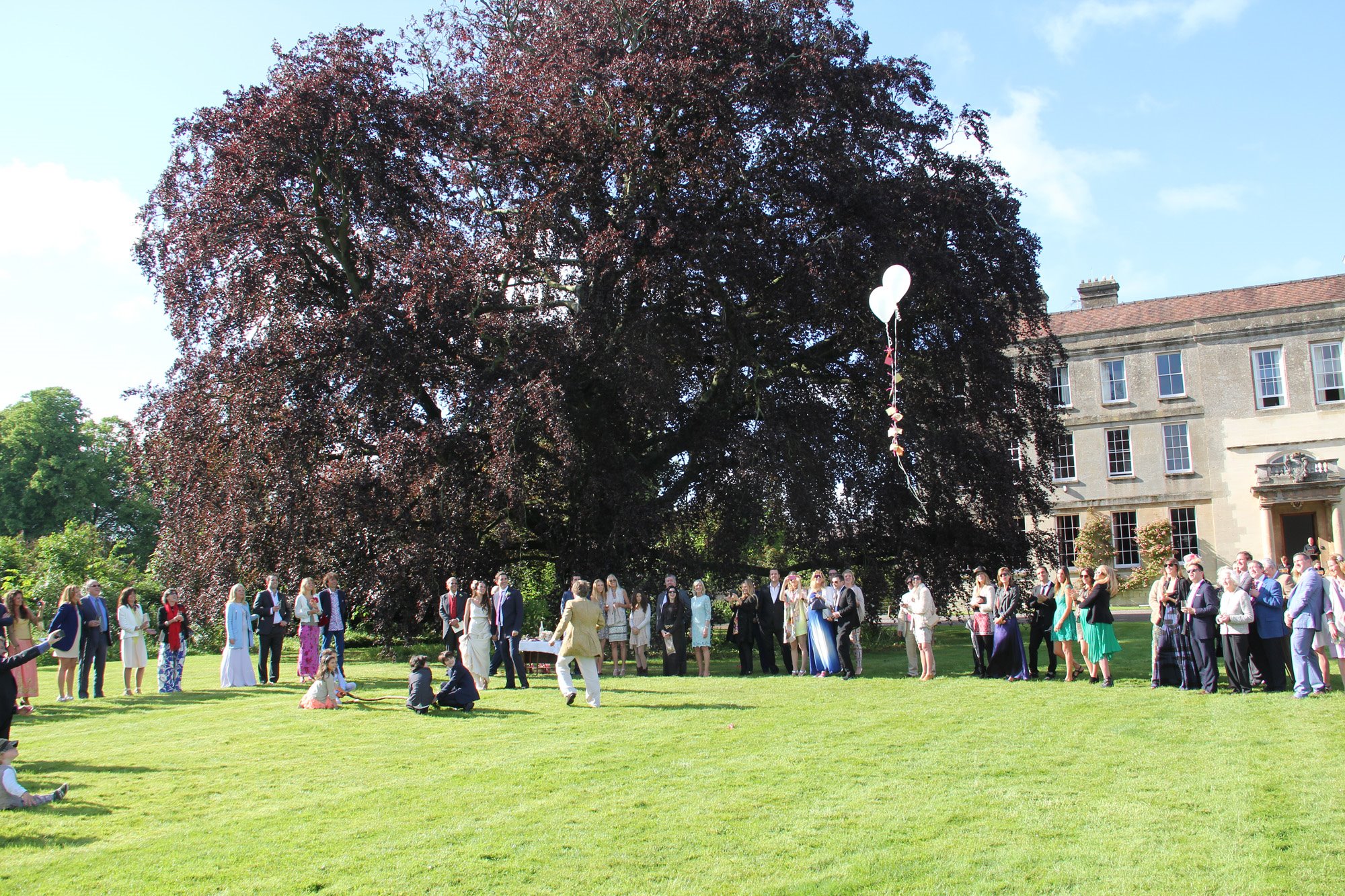 Outdoor festival wedding ceremony on the lawn of elmore court in gloucestershire