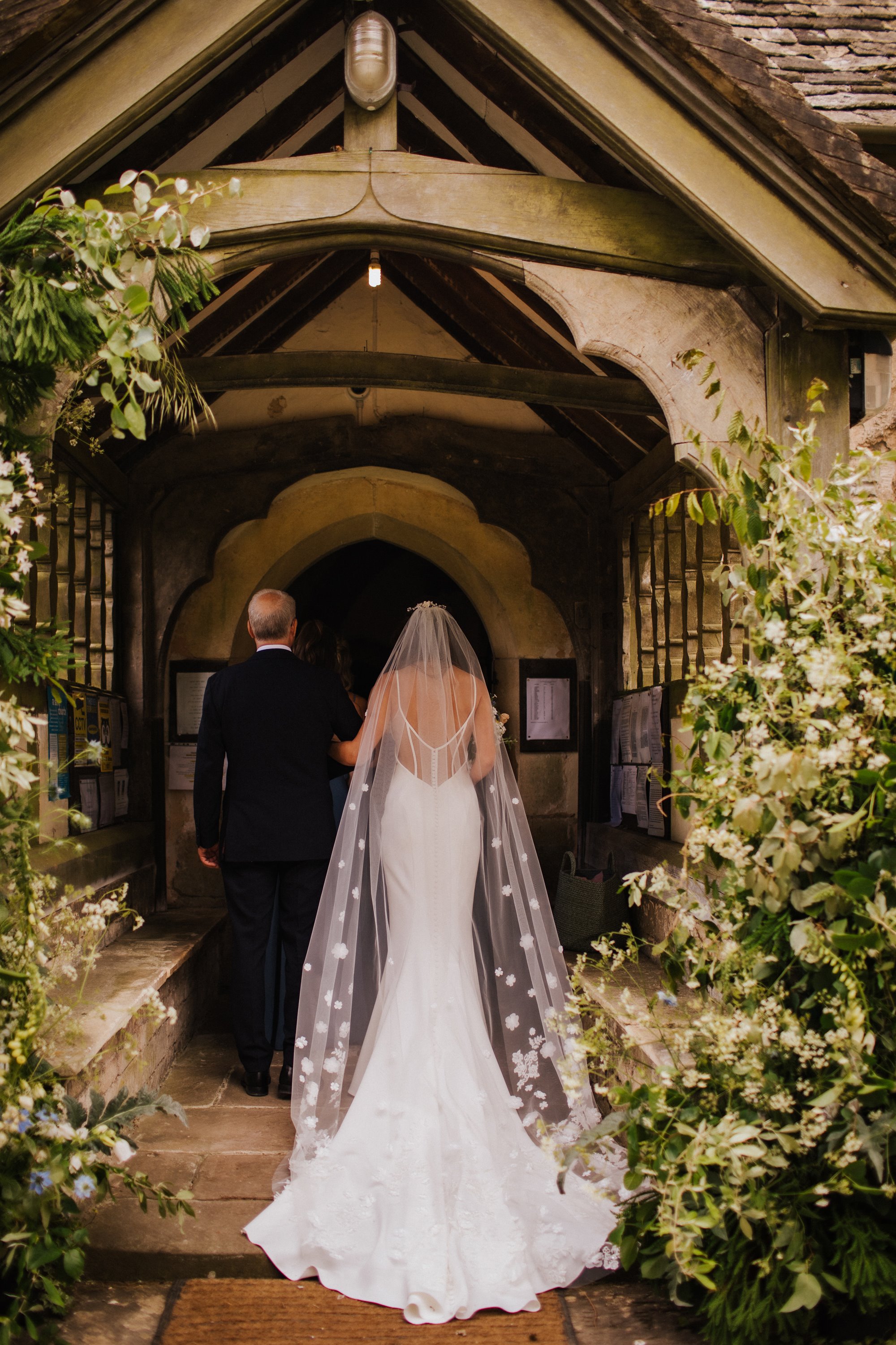 father of the bride walking her into a church wedding in gloucestershire