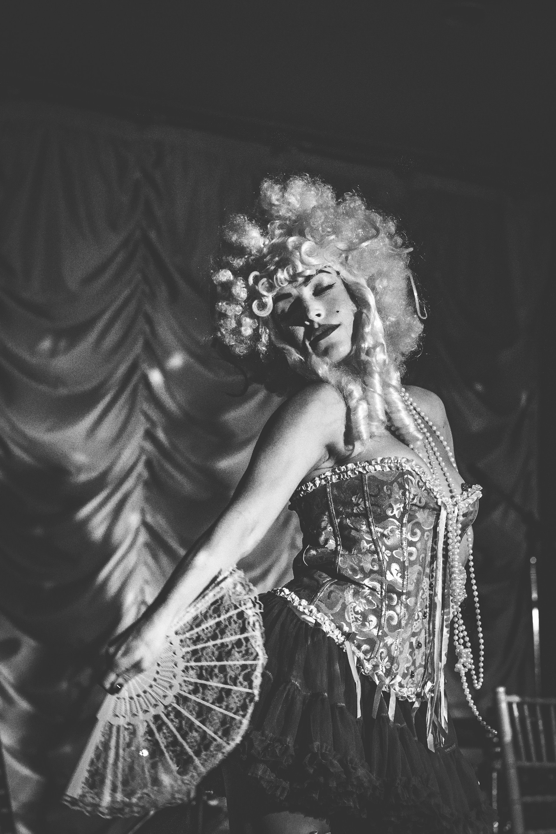 Cabaret rouge perform marie antoinette routine in curly wigs and corsets holding fans