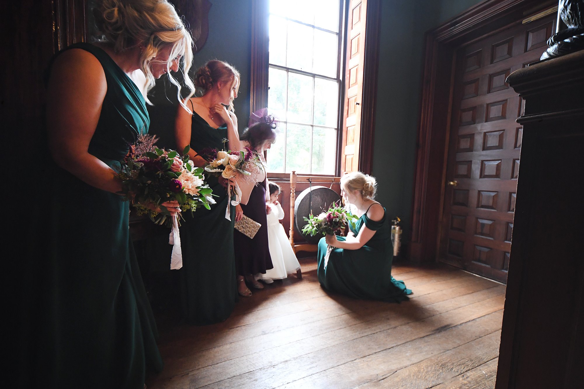 Autumn bridesmaids in green at stately home wedding venue for halloween wedding