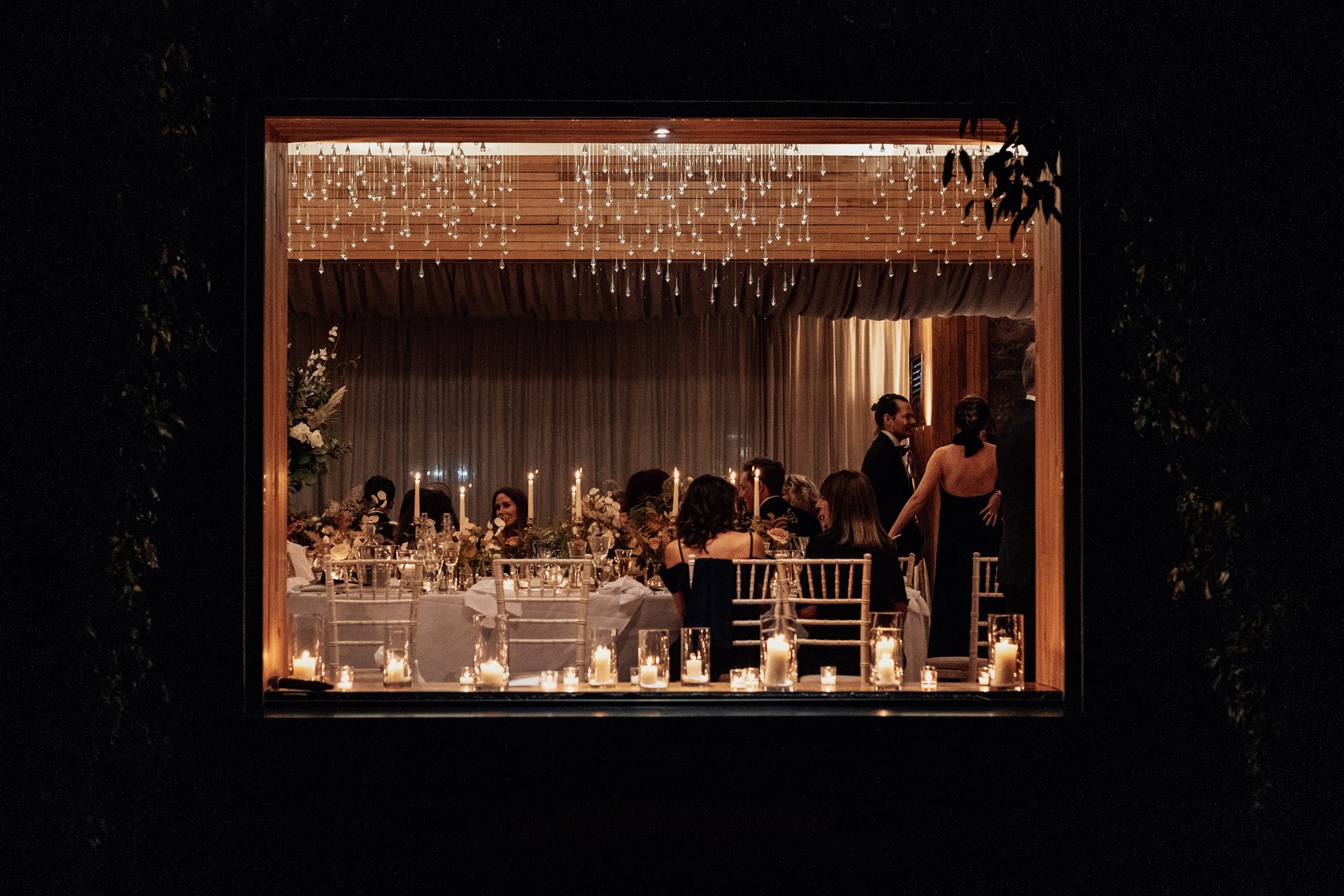 window framed shot of a wedding reception party at Elmore Court