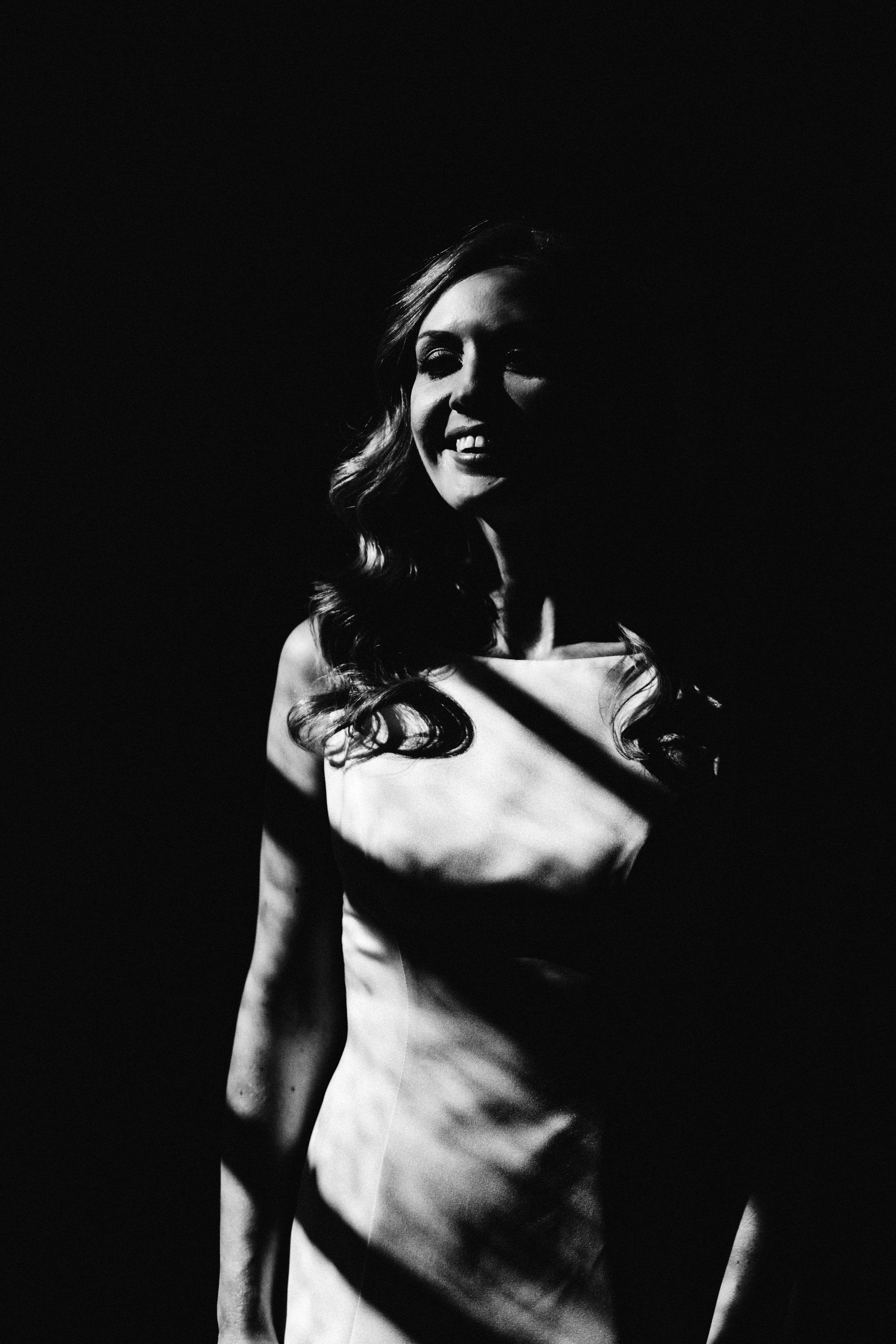 Moody black and white photo of a dark and glamorous bride on her magical autumnal october wedding day